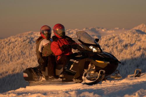 mountain snowmobiling at sunset
